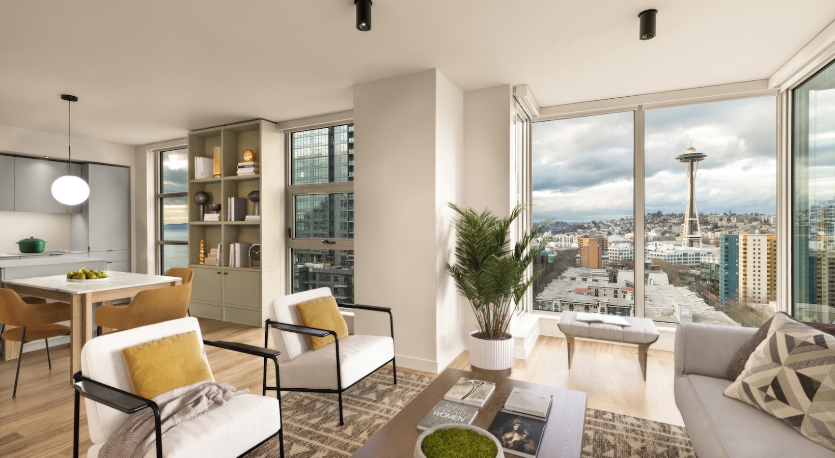 Spacious living room at Kaye Belltown luxury apartment in Seattle with floor-to-ceiling windows and skyline views