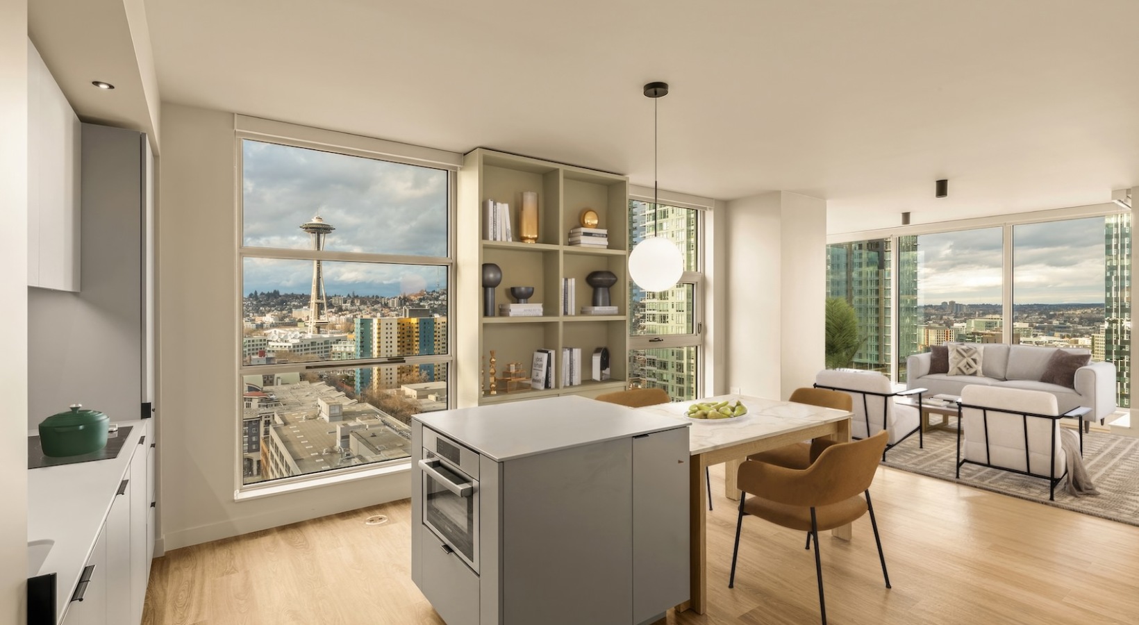 Luxury apartment kitchen with quartz countertops, stainless steel appliances, and custom cabinetry at Kaye Belltown